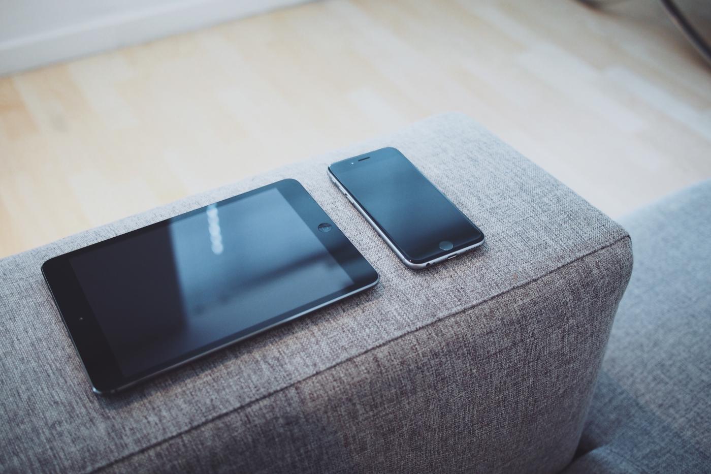 Tablet and phone on sofa arm